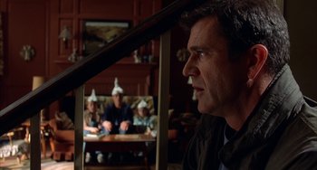 Movie still from “Signs” (2002), directed by M. Night Shyamalan – A group of people sitting in a living room; Medium shot, Over the shoulder angle