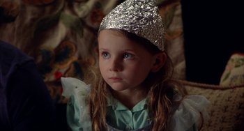 Movie still from “Signs” (2002), directed by M. Night Shyamalan – A little girl wearing a tin foil hat looking at the camera; Close Up shot, High angle