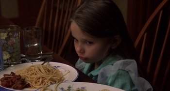 Movie still from “Signs” (2002), directed by M. Night Shyamalan – A little girl sitting in front of a plate of pasta; Close Up shot, High angle
