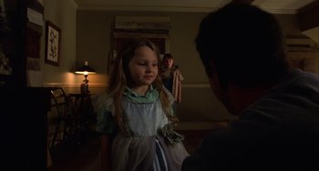Movie still from “Signs” (2002), directed by M. Night Shyamalan – A little girl wearing a dress in the dark; Medium shot, Over the shoulder angle