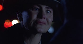 Movie still from “Signs” (2002), directed by M. Night Shyamalan – A person wearing a hat in the dark; Close Up shot, Over the shoulder angle