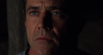 Movie still from “Signs” (2002), directed by M. Night Shyamalan – A person's face in the dark; Close Up shot, Low angle