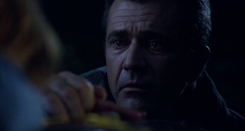Movie still from “Signs” (2002), directed by M. Night Shyamalan – A person eating something in the dark; Close Up shot, Low angle