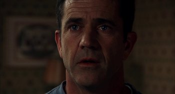 Movie still from “Signs” (2002), directed by M. Night Shyamalan – A person looking at the camera; Close Up shot, Over the shoulder angle