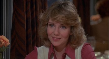 Movie still from “Silver Streak” (1976), directed by Arthur Hiller – A person wearing a vest and smiling; Close Up shot, Over the shoulder angle