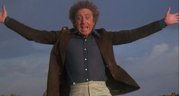 Movie still from “Silver Streak” (1976), directed by Arthur Hiller – An older man in a brown jacket and white pants; Medium shot, Low angle
