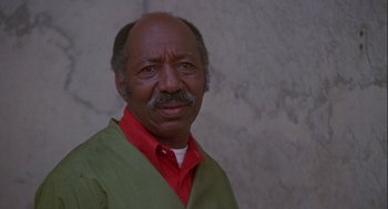 Movie still from “Silver Streak” (1976), directed by Arthur Hiller – An older man wearing a green and red shirt; Close Up shot, Low angle