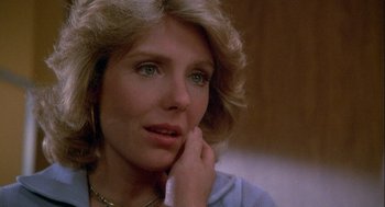 Movie still from “Silver Streak” (1976), directed by Arthur Hiller – A person with a hand on her chin; Close Up shot, Over the shoulder angle