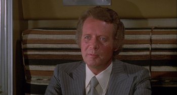 Movie still from “Silver Streak” (1976), directed by Arthur Hiller – A person wearing a suit and tie; Close Up shot, High angle