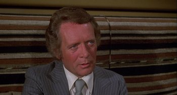 Movie still from “Silver Streak” (1976), directed by Arthur Hiller – An older man wearing a suit and tie; Close Up shot, High angle
