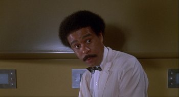 Movie still from “Silver Streak” (1976), directed by Arthur Hiller – A man in a white shirt and a bow tie; Close Up shot, Low angle