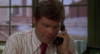 Movie still from “Silver Streak” (1976), directed by Arthur Hiller – A person talking on a phone; Close Up shot, High angle
