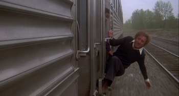 Movie still from “Silver Streak” (1976), directed by Arthur Hiller – Two people are climbing on a train car; Wide shot, Low angle