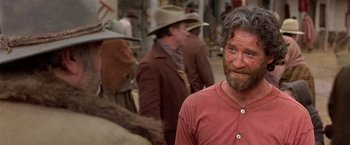 Movie still from “Silverado” (1985), directed by Lawrence Kasdan – A group of men standing next to each other on a street; Close Up shot, Over the shoulder angle