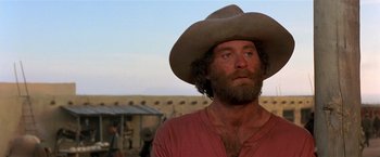 Movie still from “Silverado” (1985), directed by Lawrence Kasdan – A man in a cowboy hat looking up at the sky; Close Up shot, Low angle
