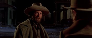 Movie still from “Silverado” (1985), directed by Lawrence Kasdan – A man with a beard wearing a cowboy hat; Close Up shot, Low angle