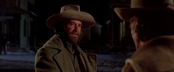 Movie still from “Silverado” (1985), directed by Lawrence Kasdan – A man with a beard wearing a cowboy hat; Close Up shot, Low angle