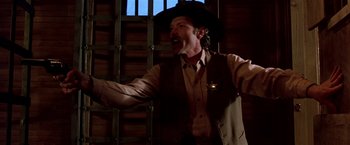 A man wearing a cowboy hat and a vest