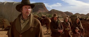 Movie still from “Silverado” (1985), directed by Lawrence Kasdan – A couple of men standing next to horses on top of a hill; Medium shot, Low angle