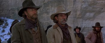 Movie still from “Silverado” (1985), directed by Lawrence Kasdan – A couple of men standing next to each other; Medium shot, Low angle