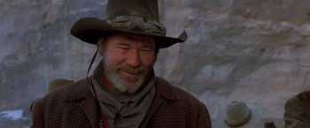 Movie still from “Silverado” (1985), directed by Lawrence Kasdan – An older man wearing a cowboy hat and smiling for the camera; Close Up shot, Low angle