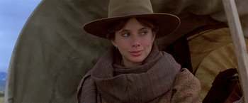 Movie still from “Silverado” (1985), directed by Lawrence Kasdan – A young woman wearing a hat and a scarf; Close Up shot, Over the shoulder angle