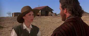 Movie still from “Silverado” (1985), directed by Lawrence Kasdan – A man and a woman talking in a dirt field; Medium shot, Over the shoulder angle
