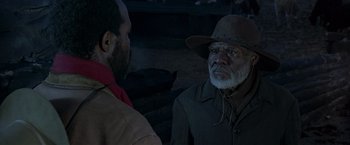 Movie still from “Silverado” (1985), directed by Lawrence Kasdan – A man wearing a hat talking to another man; Close Up shot, Over the shoulder angle