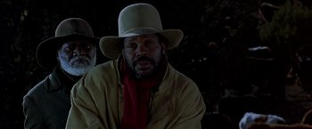 Movie still from “Silverado” (1985), directed by Lawrence Kasdan – A man wearing a cowboy hat and a red scarf; Close Up shot, Low angle