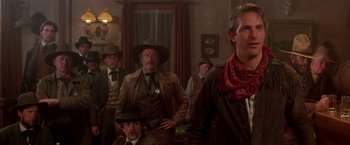 Movie still from “Silverado” (1985), directed by Lawrence Kasdan – A group of men standing in front of a window; Medium shot, Low angle