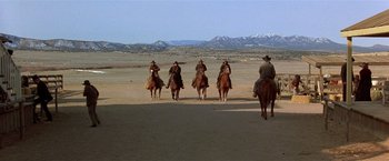 Movie still from “Silverado” (1985), directed by Lawrence Kasdan – A group of men riding on the backs of horses; Extreme Wide shot, Low angle