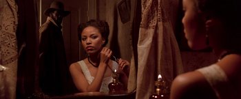 Movie still from “Silverado” (1985), directed by Lawrence Kasdan – A woman is sitting in front of a bathroom mirror; Close Up shot, Over the shoulder angle