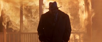 Movie still from “Silverado” (1985), directed by Lawrence Kasdan – A man wearing a hat and a suit and tie; Medium shot, Low angle