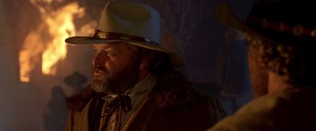 Movie still from “Silverado” (1985), directed by Lawrence Kasdan – A man with a white hat and a beard; Close Up shot, Over the shoulder angle