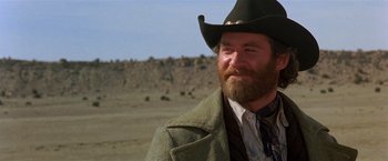 Movie still from “Silverado” (1985), directed by Lawrence Kasdan – A man with a beard and a cowboy hat; Close Up shot, Low angle