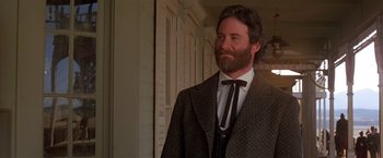 Movie still from “Silverado” (1985), directed by Lawrence Kasdan – A man with a long beard wearing a suit and tie; Close Up shot, Low angle