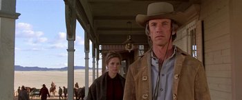 Movie still from “Silverado” (1985), directed by Lawrence Kasdan – A man and a woman standing next to each other; Medium shot, Low angle