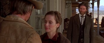 Movie still from “Silverado” (1985), directed by Lawrence Kasdan – A woman in a hat and a dress is talking to a man in a cowboy hat; Close Up shot, Over the shoulder angle