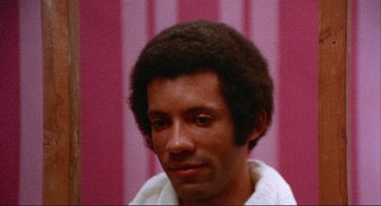 Movie still from “Sisters” (1972), directed by Brian De Palma – A person wearing a white towel; Close Up shot, High angle