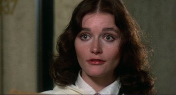 Movie still from “Sisters” (1972), directed by Brian De Palma – A person wearing a shirt and tie; Close Up shot, High angle