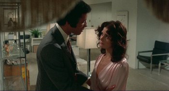 Movie still from “Sisters” (1972), directed by Brian De Palma – A man and a woman talking to each other; Medium shot, Over the shoulder angle