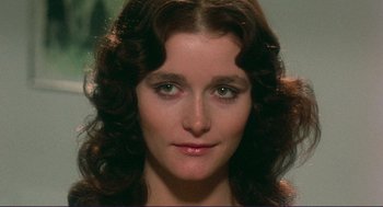 Movie still from “Sisters” (1972), directed by Brian De Palma – A woman's face in a dark room; Close Up shot, Low angle