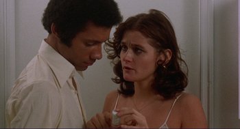 Movie still from “Sisters” (1972), directed by Brian De Palma – A man and a woman looking at each other; Close Up shot, High angle