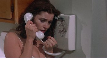 Movie still from “Sisters” (1972), directed by Brian De Palma – A woman holding a phone up to her ear; Close Up shot, High angle