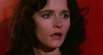 Movie still from “Sisters” (1972), directed by Brian De Palma – A woman's face as she stares into the camera; Close Up shot, Low angle