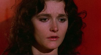 Movie still from “Sisters” (1972), directed by Brian De Palma – A woman's face with a red background; Close Up shot, High angle
