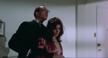 Movie still from “Sisters” (1972), directed by Brian De Palma – A man and a woman standing next to each other in a room; Medium shot, Low angle