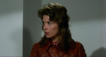 Movie still from “Sisters” (1972), directed by Brian De Palma – A person wearing a leather jacket; Close Up shot, Over the shoulder angle