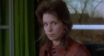 Movie still from “Sisters” (1972), directed by Brian De Palma – A person wearing a leather jacket; Close Up shot, Low angle