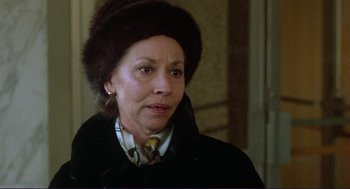 Movie still from “Sisters” (1972), directed by Brian De Palma – An older woman wearing a fur hat and a coat; Close Up shot, Over the shoulder angle